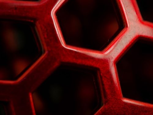 closeup-red-pattern-with-hexagon-holes 1-min